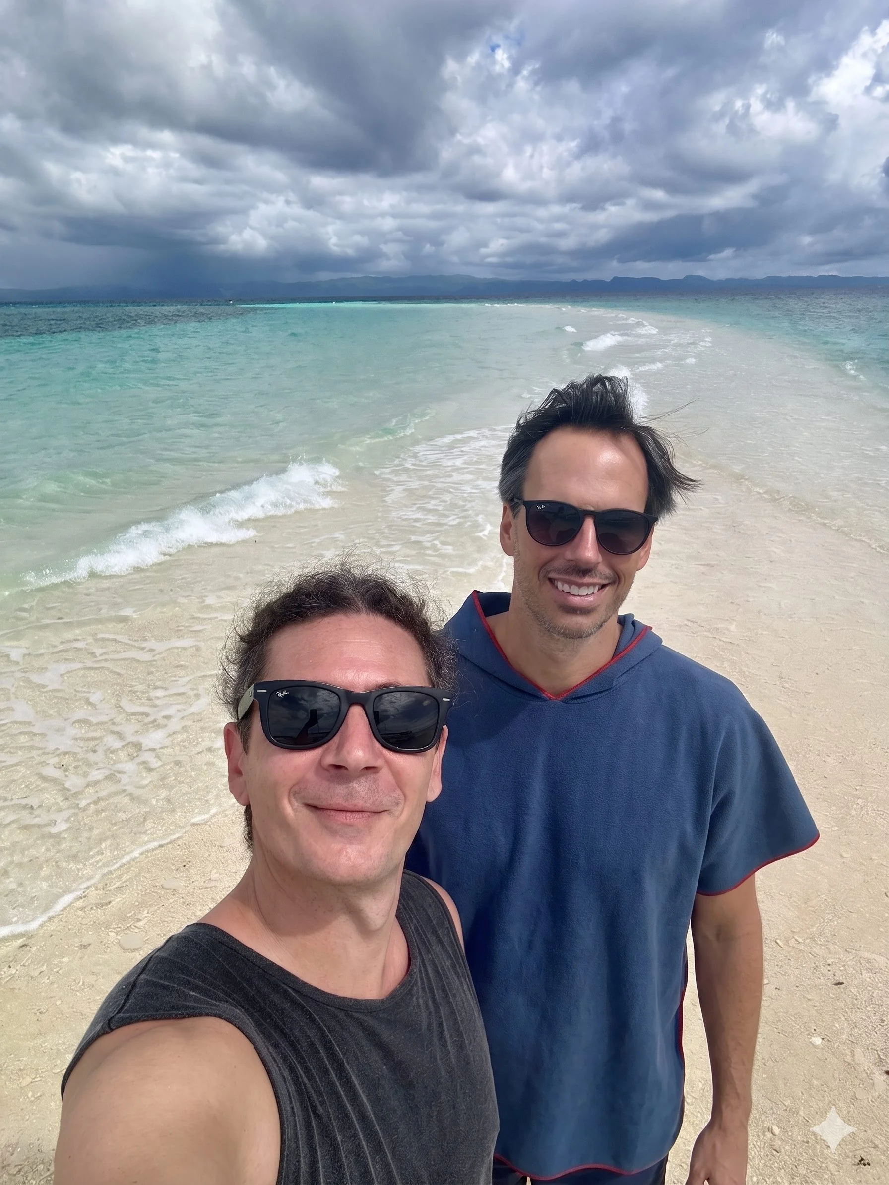Marcos and Alberto, MolaHop founders, on a sandbar surrounded by turquoise water
